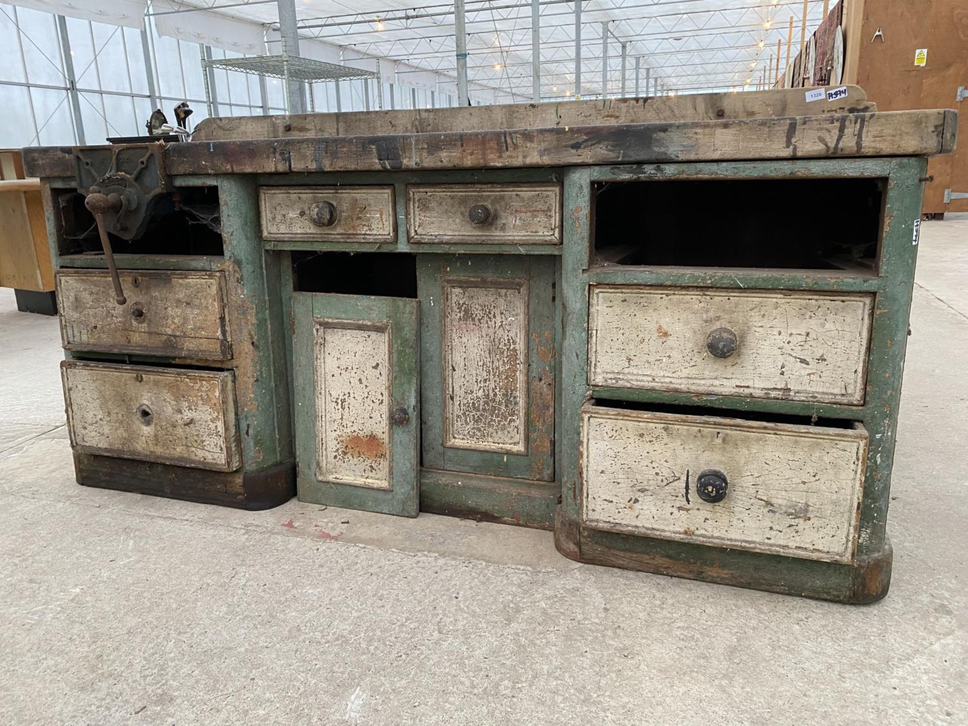 A LARGE VINTAGE WORK BENCH ENCLOSING SIX DRAWERS AND A LOWER CUPBOARD TO ALSO INCLUDE A RECORD BENCH