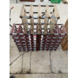 A GROUP OF THREE WOODEN AND METAL WINE RACKS 60 BOTTLES IN TOTAL