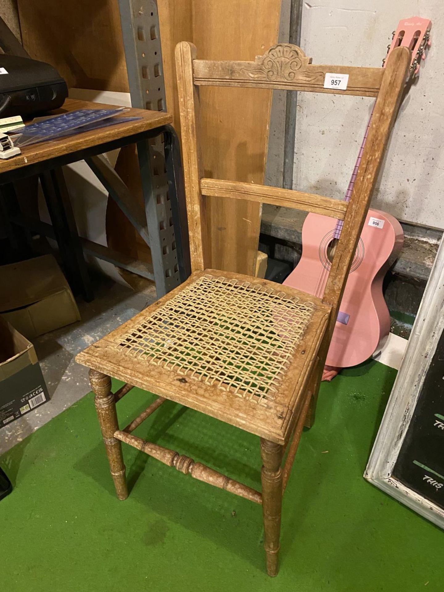 A PINE CHAIR WITH A CARVED BACK STRETCHER AND A RATTAN SEAT