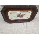 A WOODEN FRAMED MIRROR WITH FLORAL DECORATION