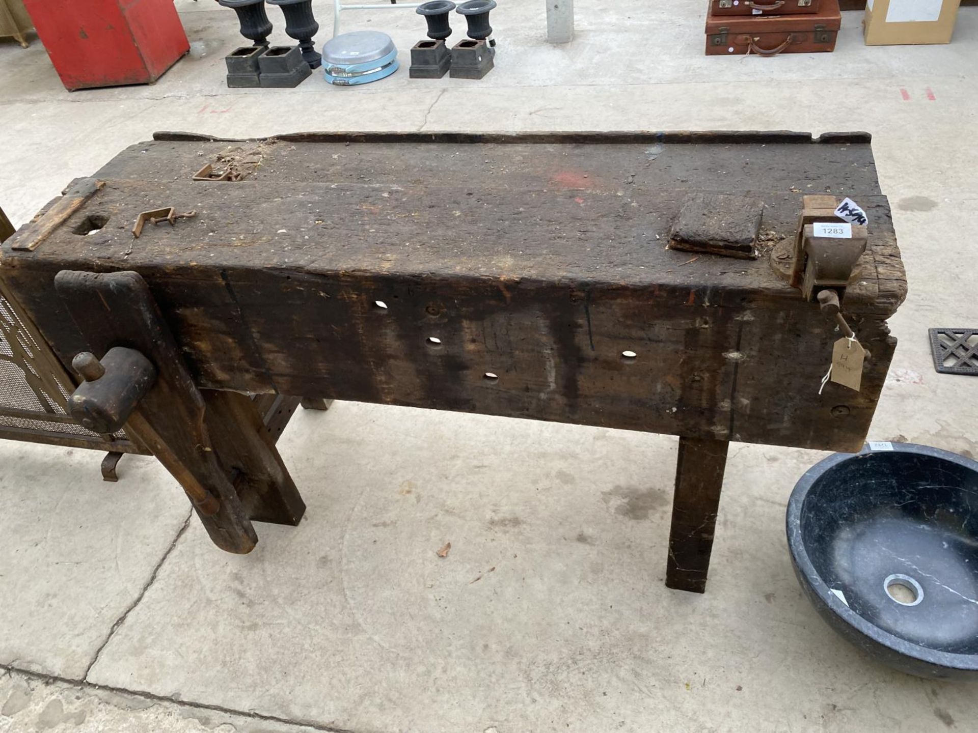 A VINTAGE WOOD WORK BENCH WITH WOODEN LEG VICE AND A SMALL RECORD BENCH VICE