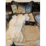 A SUITCASE CONTAINING VINTAGE CLOTHING, LINEN, BLANKET, LADYBIRD BOOKS, ETC