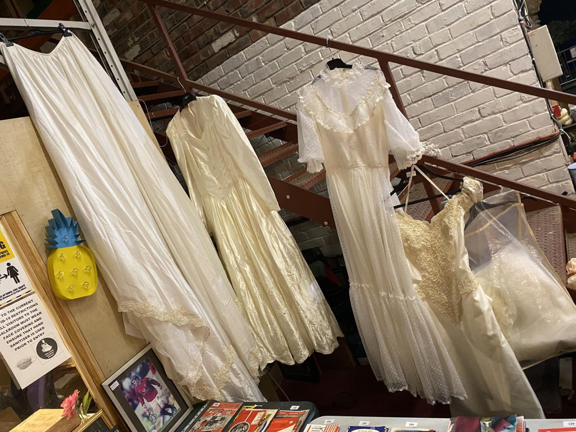 TWO FULL LENGTH WEDDING DRESSES, ONE VERY 1970'S, A SHORTER DRESS, LONG TRAIN, HEAD BAND AND VEIL