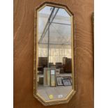 A DECORATIVE OCTAGONAL GILT FRAMED MIRROR (42CM X 97CM)