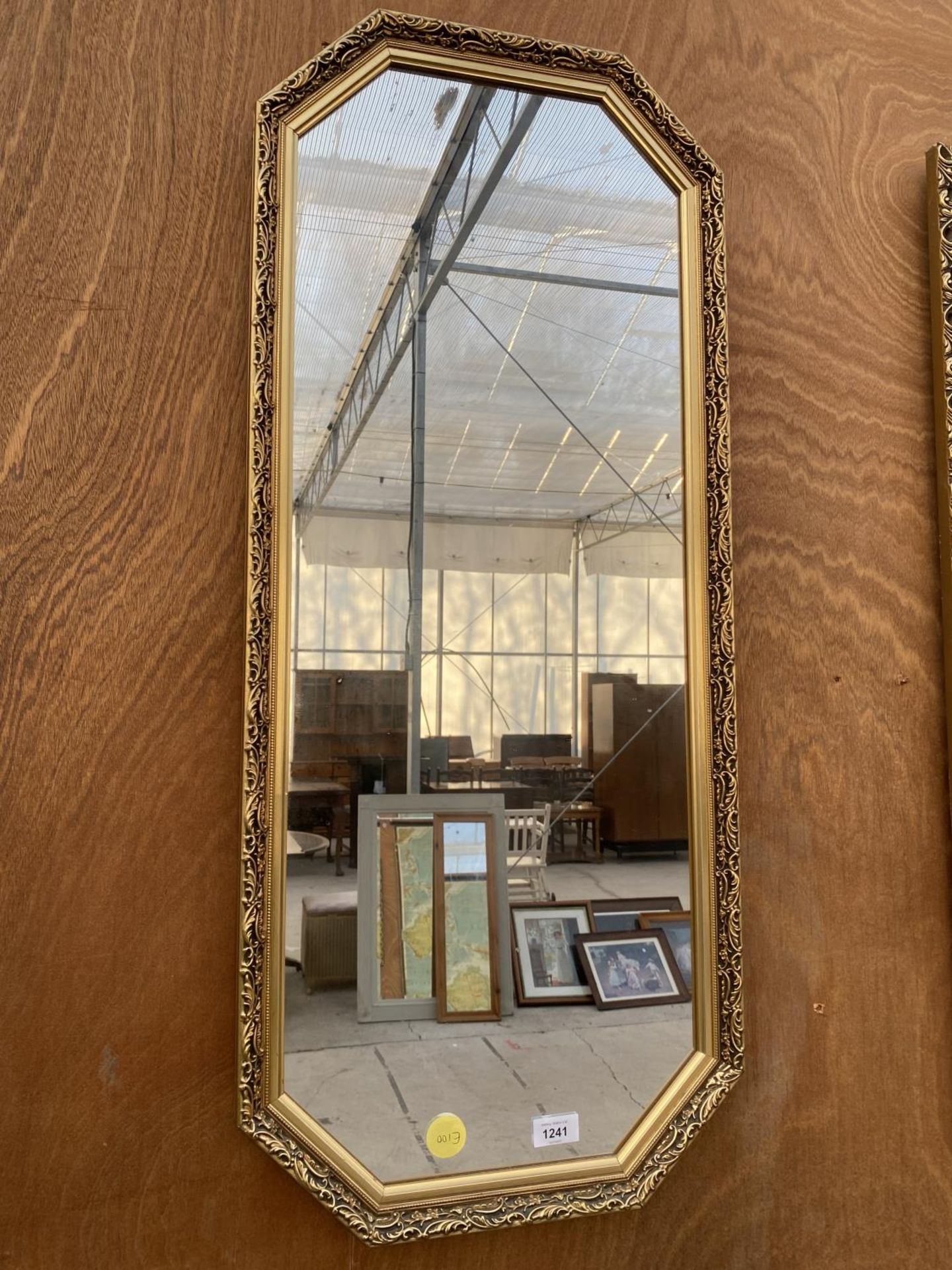 A DECORATIVE OCTAGONAL GILT FRAMED MIRROR (42CM X 97CM)