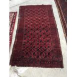 A RED GROUND RUG, 61 X 32"