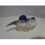 A ROYAL COPENHAGEN FIGURINE OF THREE BIRDS