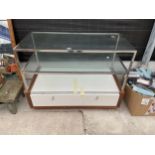 A GLASS SHOP DISPLAY UNIT, A TAGGING GUN AND AN ASSORTMENT OF SHOES ETC