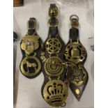 THREE LEATHER HORSE BRASS STRAPS WITH VARIOUS DESIGN BRASSES, ONE HOLDING THREE TOGETHER WITH BELL