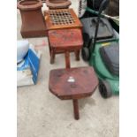 TWO THREE LEGGED STOOLS (ONE WORM DAMAGE) AND A PINE STOOL WITH WOVEN SEAT