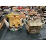 TWELVE VARIOUS NOVELTY TEAPOTS IN THE FORM OF COTTAGES