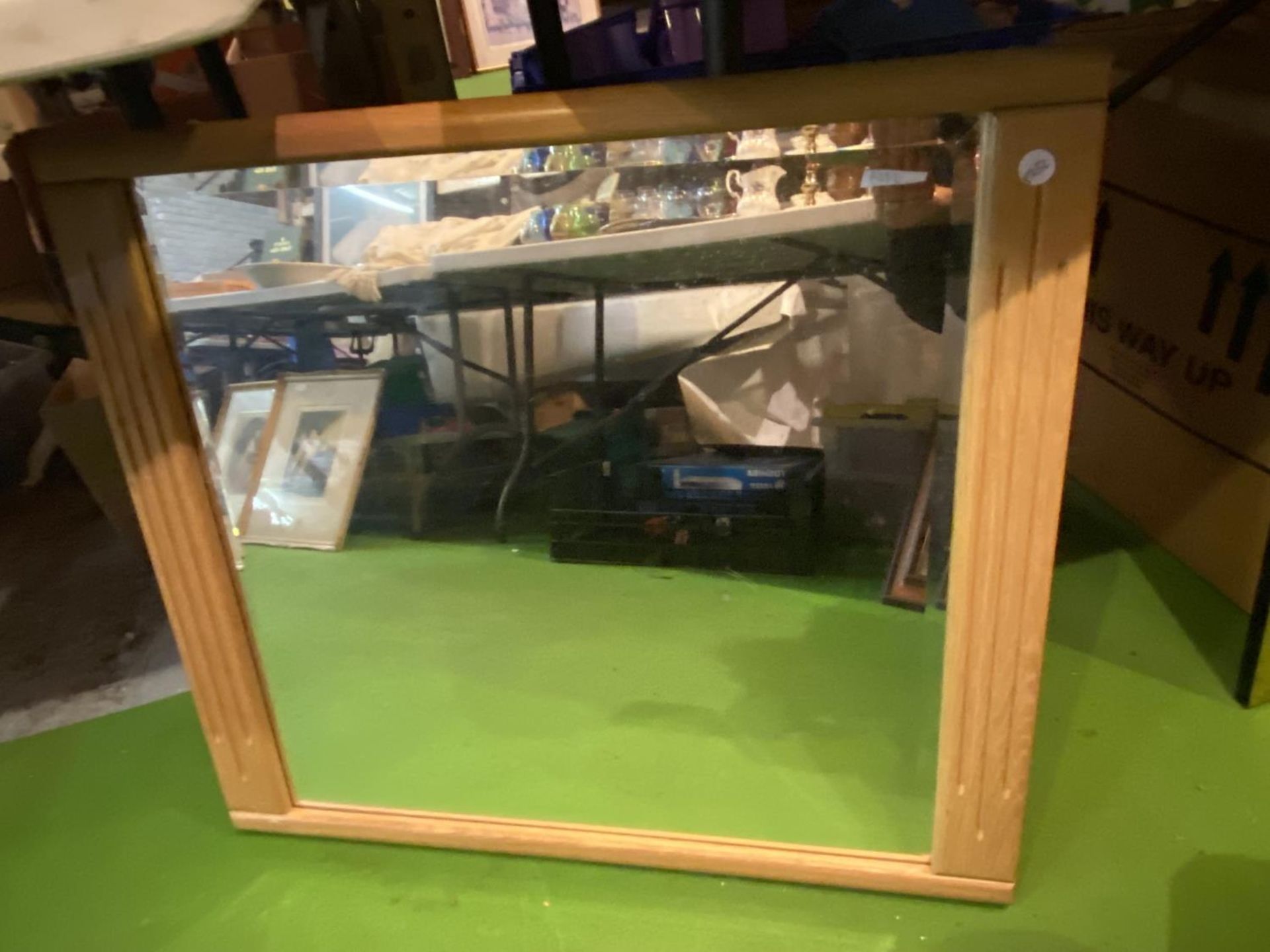 A PINE FRAMED BEVELLED GLASS MIRROR, SIZE 70CM X 63CM