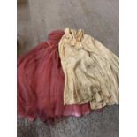 A DUSKY PINK STRAPLESS BALL GOWN AND A CREAM DRESS BOTH IN NEED OF REPAIR