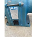 A WOLF ELECTRIC BENCH GRINDER IN WORKING ORDER BUT NO WARRANTY GIVEN