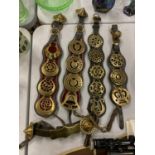 A QUANTITY OF HORSE BRASSES ON LEATHER STRAPS