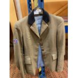 AN EQUIPORT SIZE 8 SHOWING JACKET, TWEED STYLE PATTERN, UNION JACK BADGE ON THE ARM, BACK VENTS,