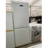 A LARGE WHITE HOTPOINT UPRIGHT FRIDGE FREEZER