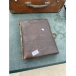 A VINTAGE LEATHER BOUND PHOTO ALBUM