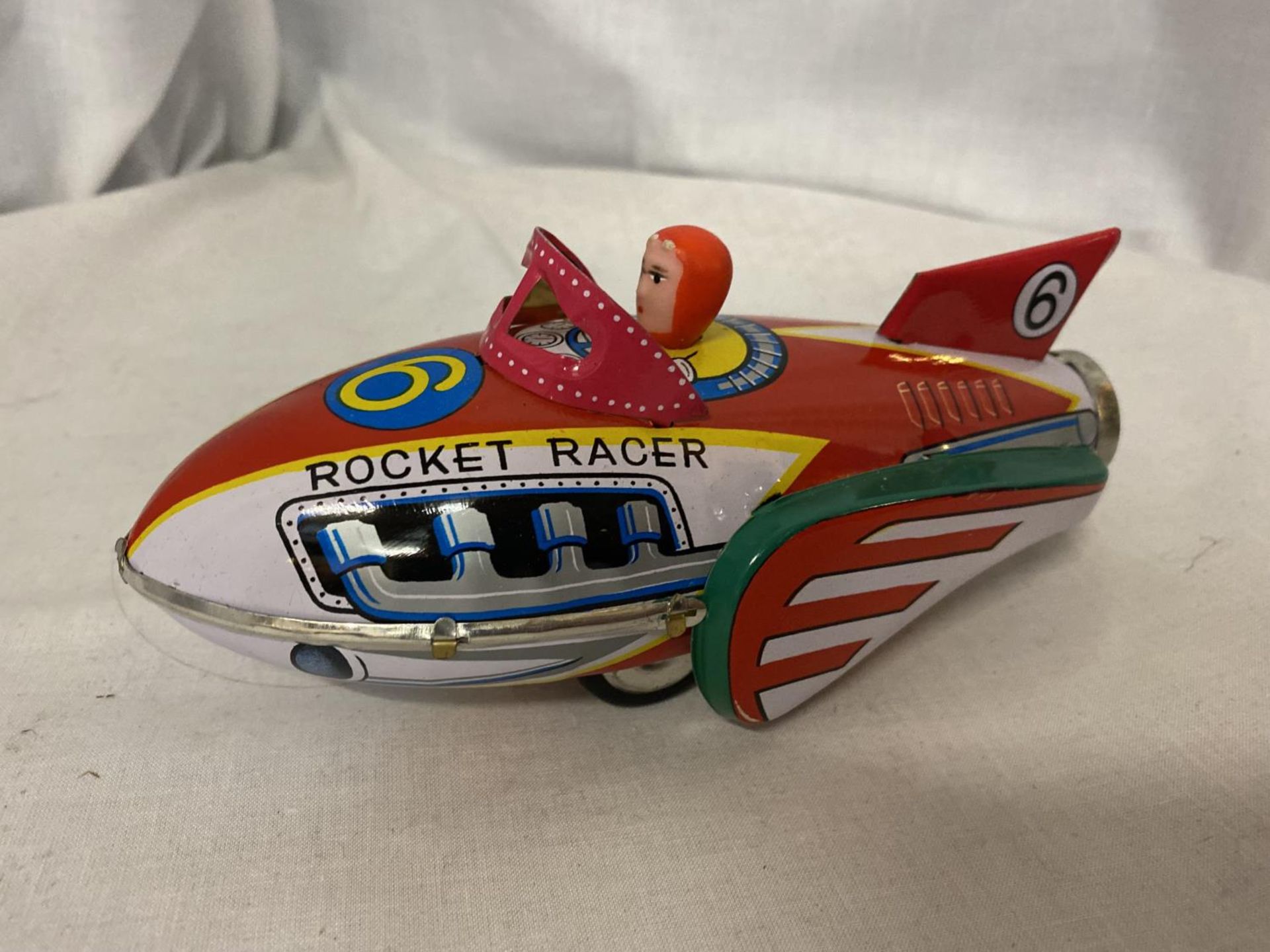 A TIN PLATE ROCKET TOY