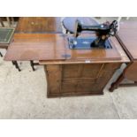 A SINGER SEWING MACHINE IN OAK CABINET COMPLETE WITH HEM STITCHER, OIL CAN, VARIOUS ACCESSORIES