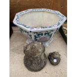 A DECORATIVE OCTAGONAL CERAMIC PLANTER AND TWO RECONSTITUTED STONE FROG GARDEN ORNAMENTS