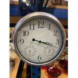 A LARGE CHROME EFFECT WALL CLOCK