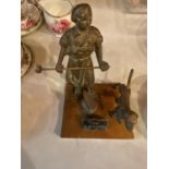 A HEAVY BRASS MODEL OF 'THE BLACKSMITH' MOUNTED ON A WOODEN BASE