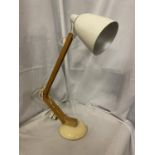 A VINTAGE STYLE ANGLEPOISE LAMP WITH A WOODEN STAND