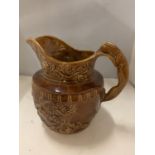 A HOUND HANDLE 'WOOD' BROWN GLAZE CERAMIC PITCHER, DEPICTING WOODLAND ANIMALS, FLORA AND FAUNA,