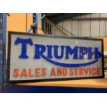 A 'TRIUMPH SALES AND SERVICE' ILLUMINATED SIGN