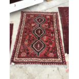 A RED GROUND RUG, 58" X 40"