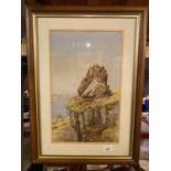 A WOODEN FRAMED PICTURE OF A CLIFF OVERLOOKING THE SEA