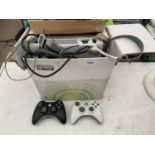 AN XBOX 360 WITH TWO CONTROLLERS AND A HEADSET