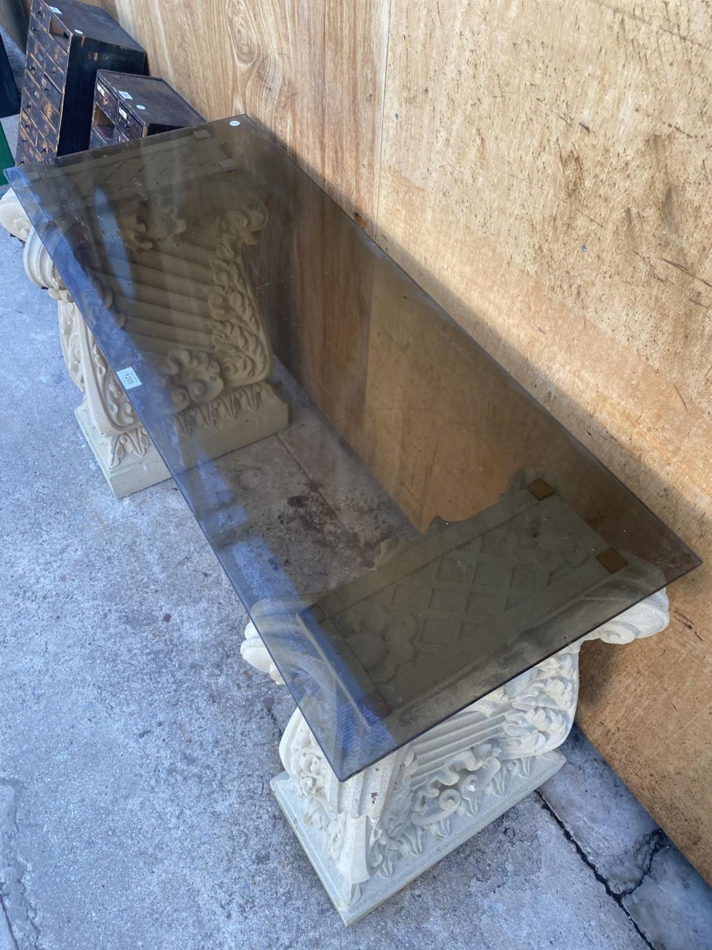 A GLASS TOPPED TABLE WITH RECONSTITUTED STONE PEDASTEL BASES (L:121CM H:73CM) - Image 4 of 5