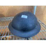 A VINTAGE MILITARY HELMET