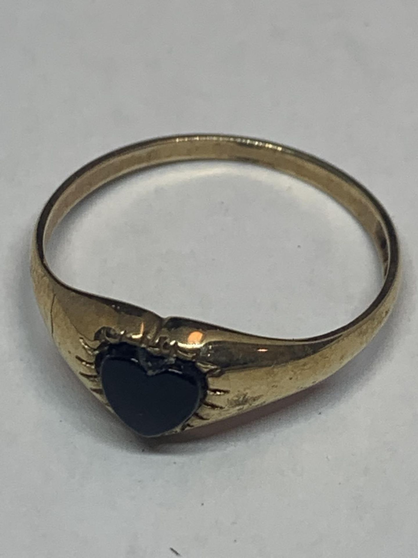 A 9 CARAT GOLD RING WITH ONYX HEART SHAPED STONE SIZE M/N