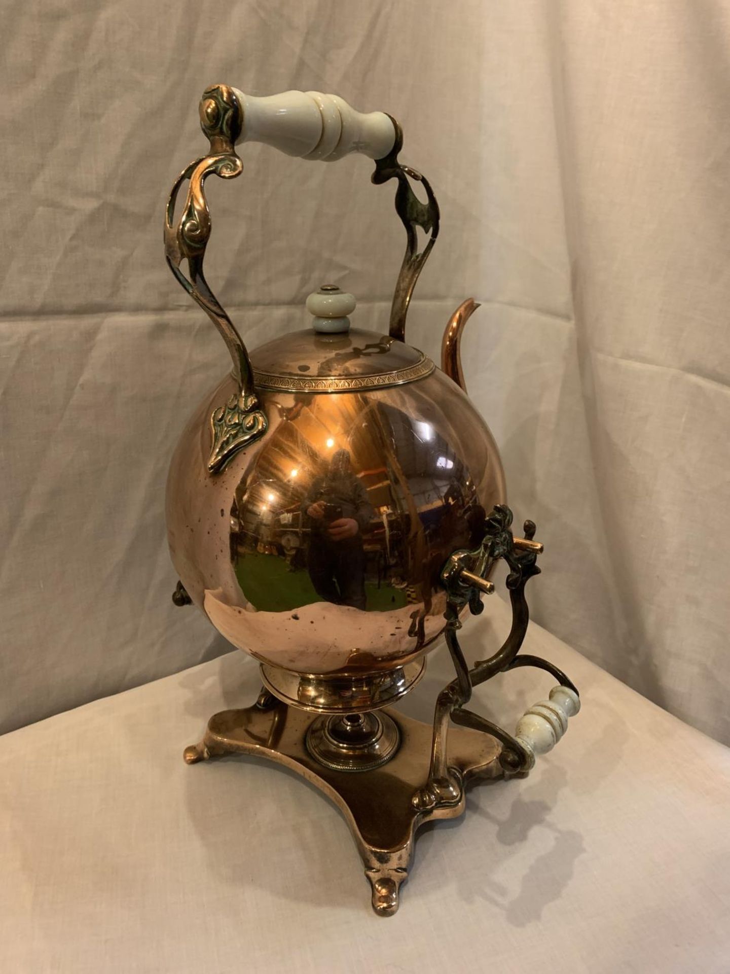 A VINTAGE COPPER KETTLE ON A STAND