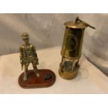 A HEAVY BRASS SAFETY LAMP AND A BRASS MINER WITH COAL ON A PLINTH