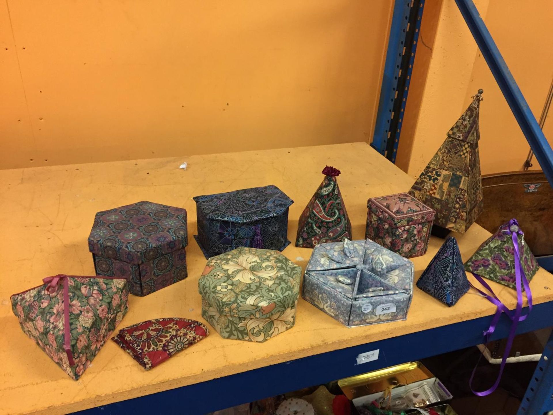 A NUMBER OF QUILTED LIDDED BOXES IN DIFFERENT FABRIC DESIGNS