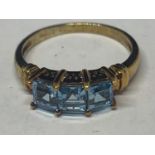 A 9 CARAT GOLD RING MARKED 375 WITH THREE IN LINE SWISS BLUE TOPAZ STONES SIZE N GROSS WEIGHT 2.4