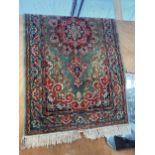 A FRINGED RED PATTERNED RUG