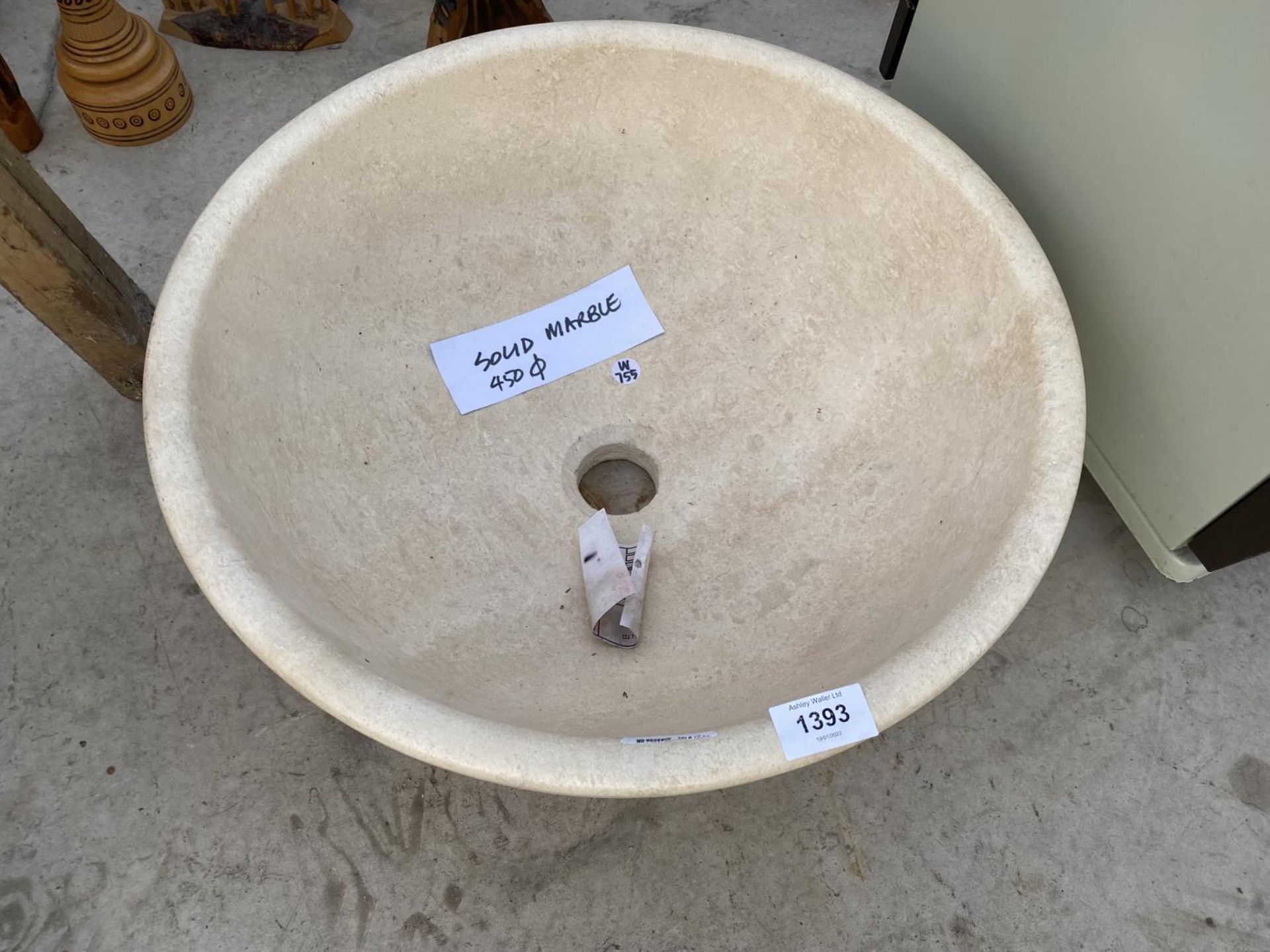 A CREAM WASH BASIN FORMED FROM A PIECE OF MARBLE
