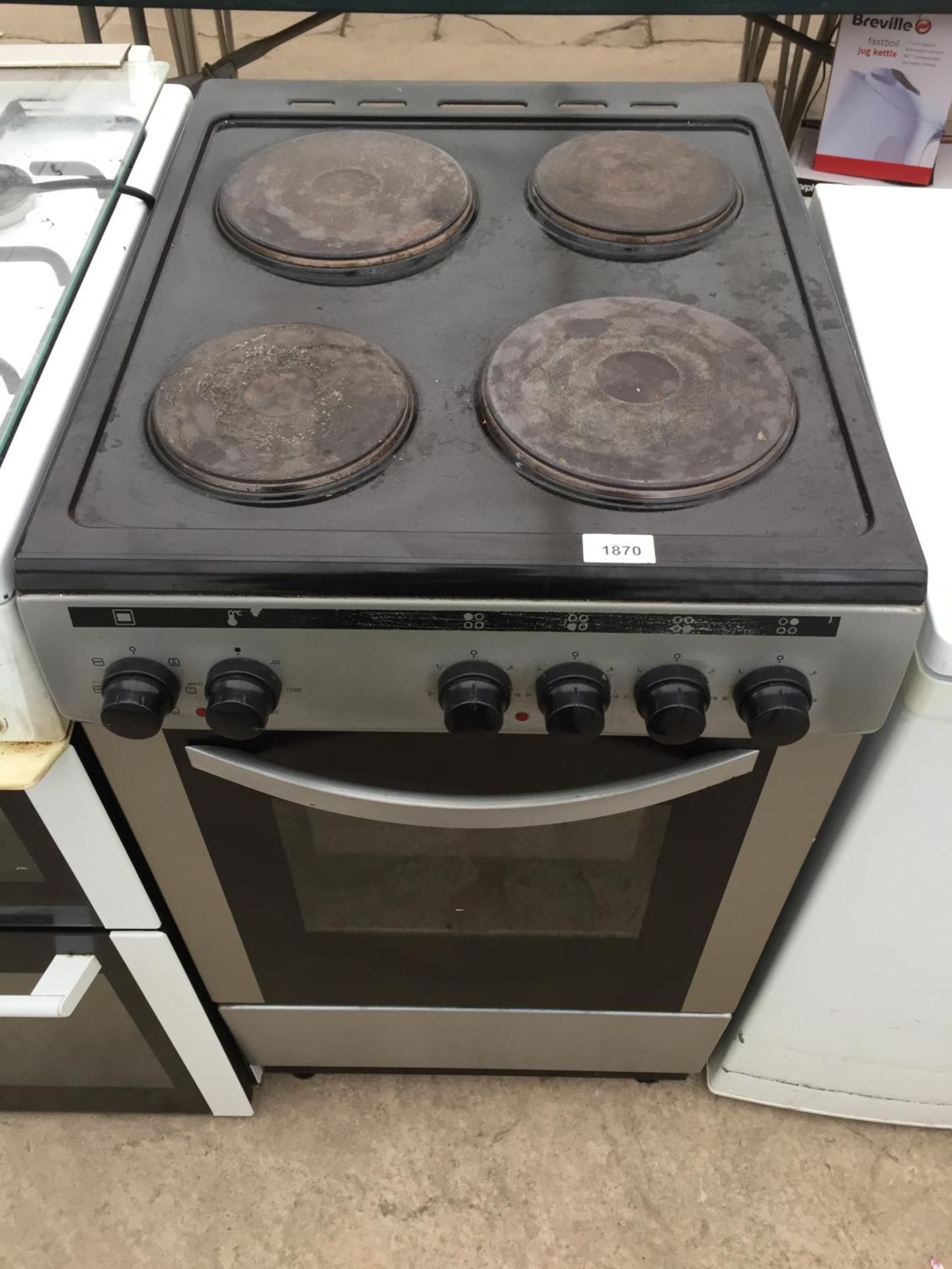 A SILVER AND BLACK FREESTANDING OVEN AND HOB