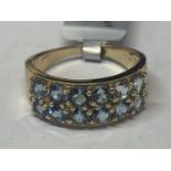 A 9 CARAT GOLD RING MARKED 375 WITH TEN PALE BLUE STONES SIZE R/S GROSS WEIGHT 4.4 GRAMS IN A