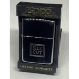 A NEW AND BOXED 'SILK CUT' ZIPPO LIGHTER