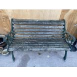 A WOODEN SLATTED GARDEN BENCH WITH CAST BENCH ENDS