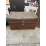 A VINTAGE METAL STORAGE TRUNK WITH AN ASSORTMENT OF MATERIAL