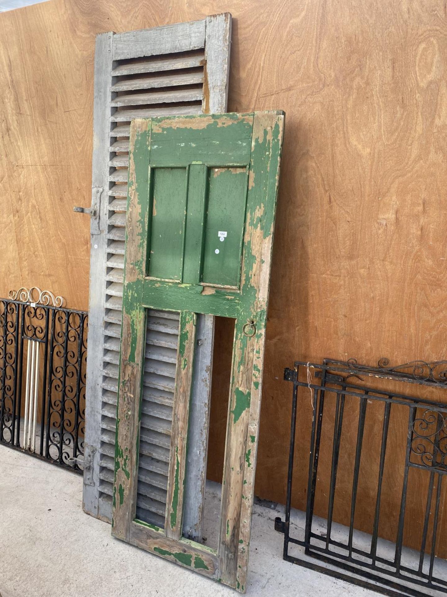 A VINTAGE WOODEN FRENCH WINDOW SHUTTER AND A VINTAGE WOODEN HUNGARIAN DOOR