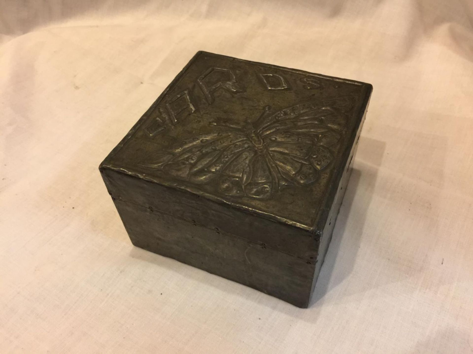 A PEWTER CARD BOX WITH BUTTERFLY DECORATION TO INCLUDE PLAYING CARDS