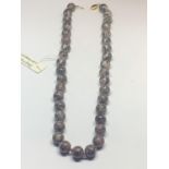 A JASPER LEOPARD SKIN NECKLACE, INDIVIDUALLY KNOTTED WITH A 14 CARAT GOLD CLASP GROSS WEIGHT 48.1